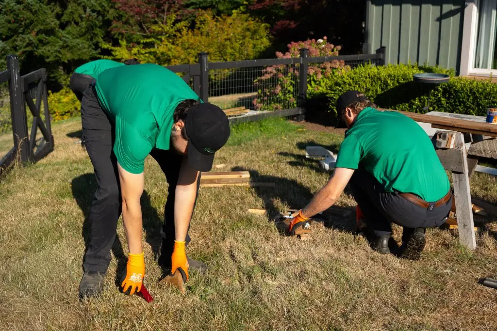 Three Fraser Valley Junk Solutions employees removing the remaining debris left behind from construction project at a Chilliwack residence.
